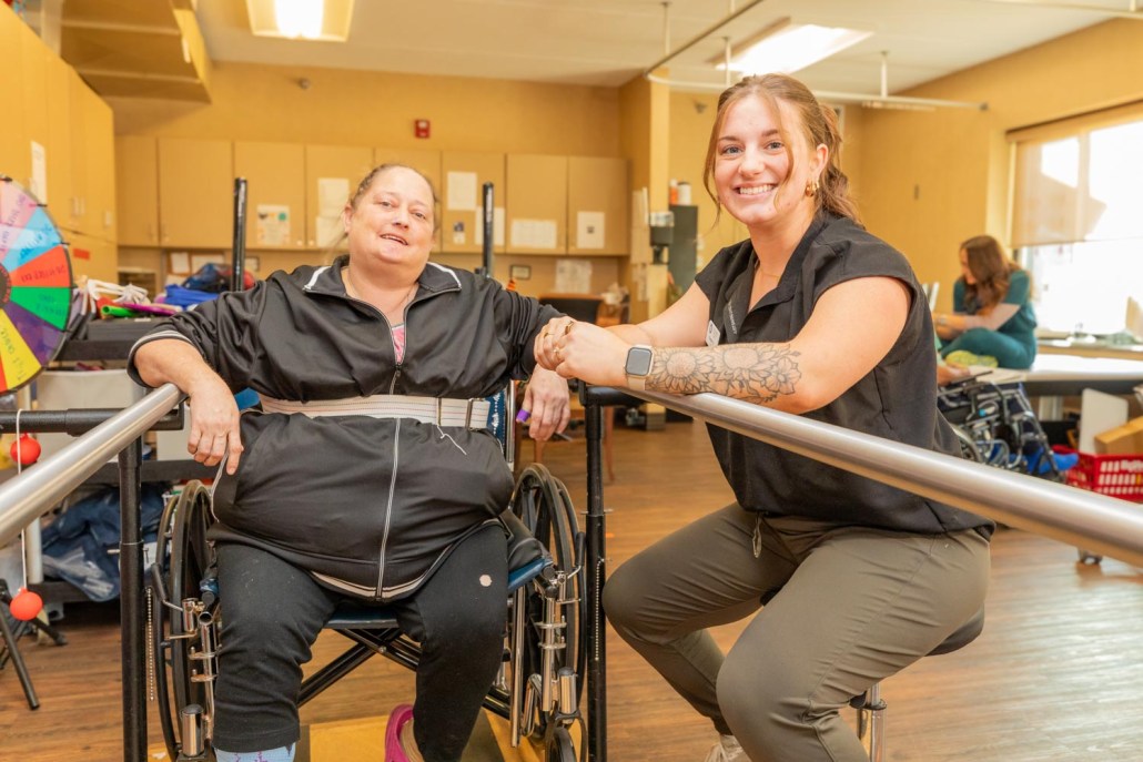 A staff member and a resident in a rehabilitation setting.