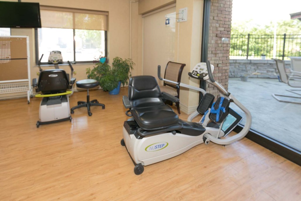 Rehabilitation exercise equipment in a bright space.