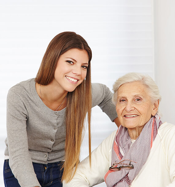 Smiling caregiver with elderly resident