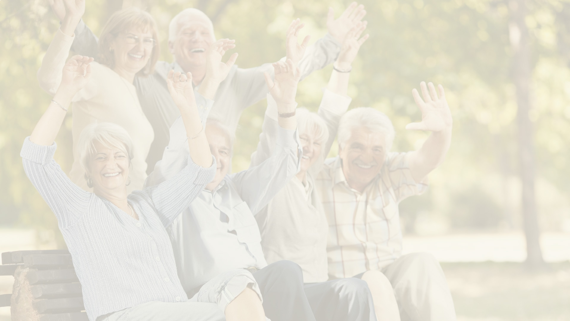 Happy seniors celebrating outdoors in a park.