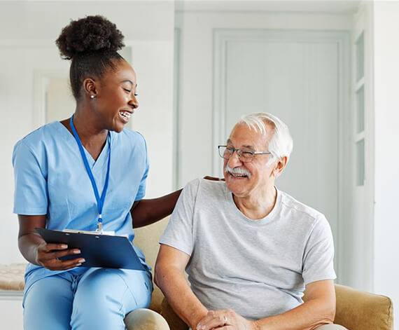 Nurse interacting with an elderly resident in a bright room