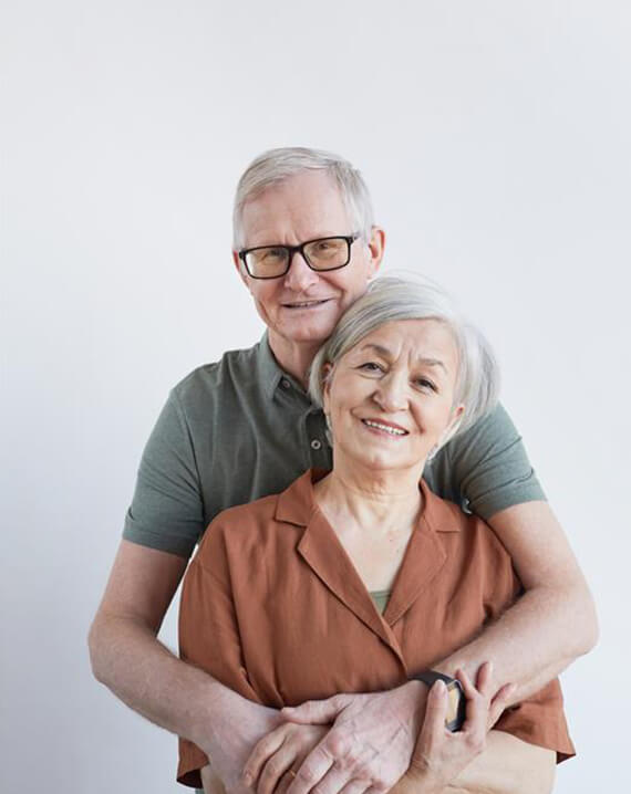 Elderly couple smiling together.