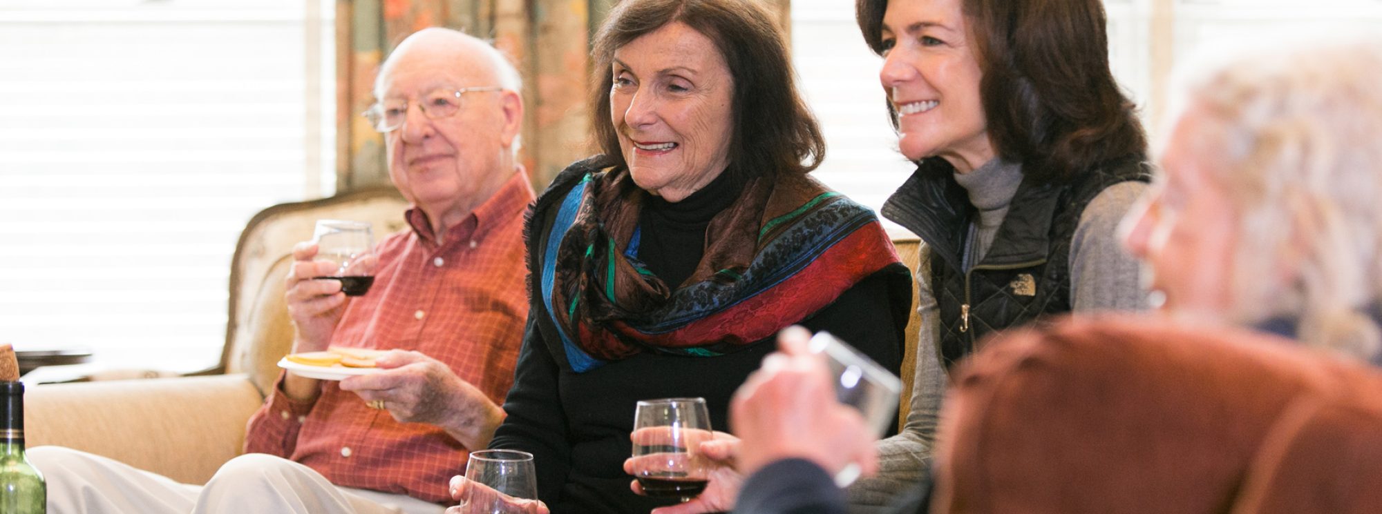 Residents enjoying drinks and conversation in a common area.