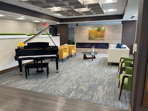 Interior lounge area with seating and a piano.