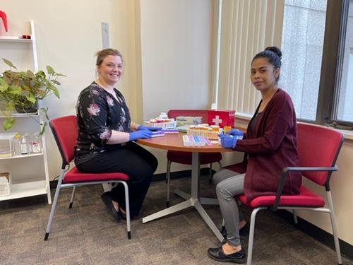 Two staff members engaged in an activity.
