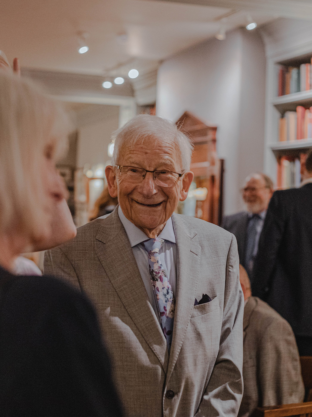 Smiling elderly man in a social setting