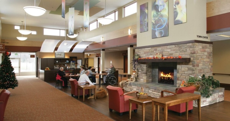 Common area with fireplace and residents enjoying the space.