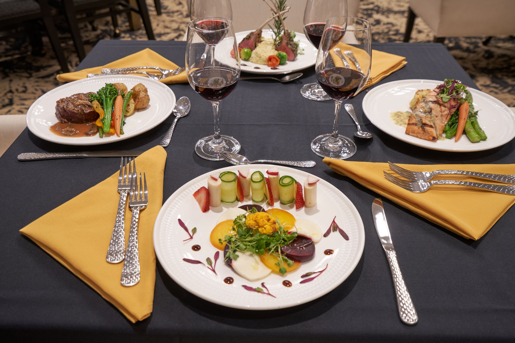Elegant dining setting with gourmet meals and wine.