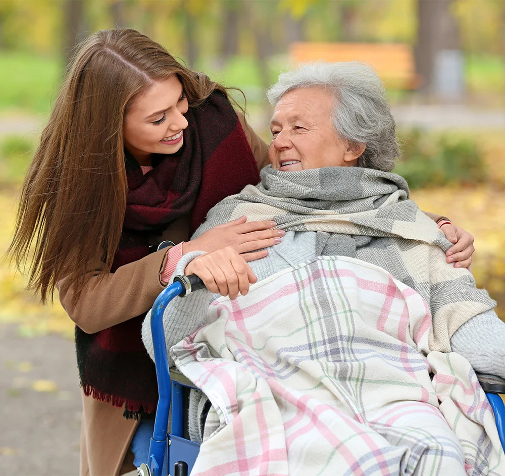 Resident enjoying time outdoors with a caregiver.