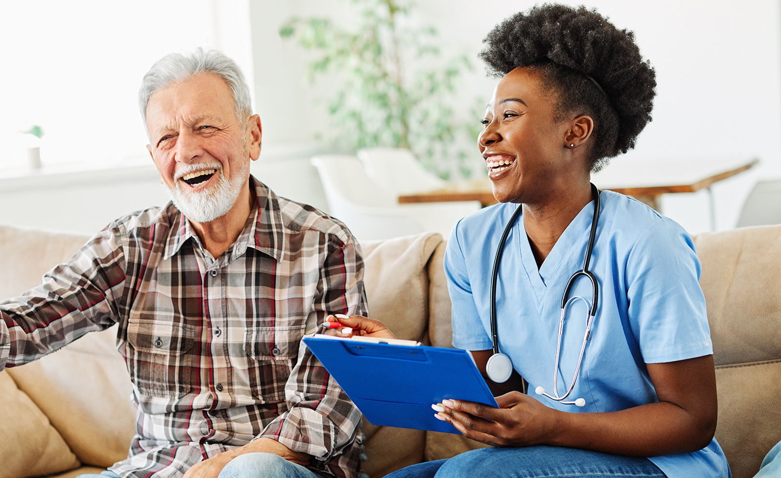 Nurse and resident sharing a joyful moment.
