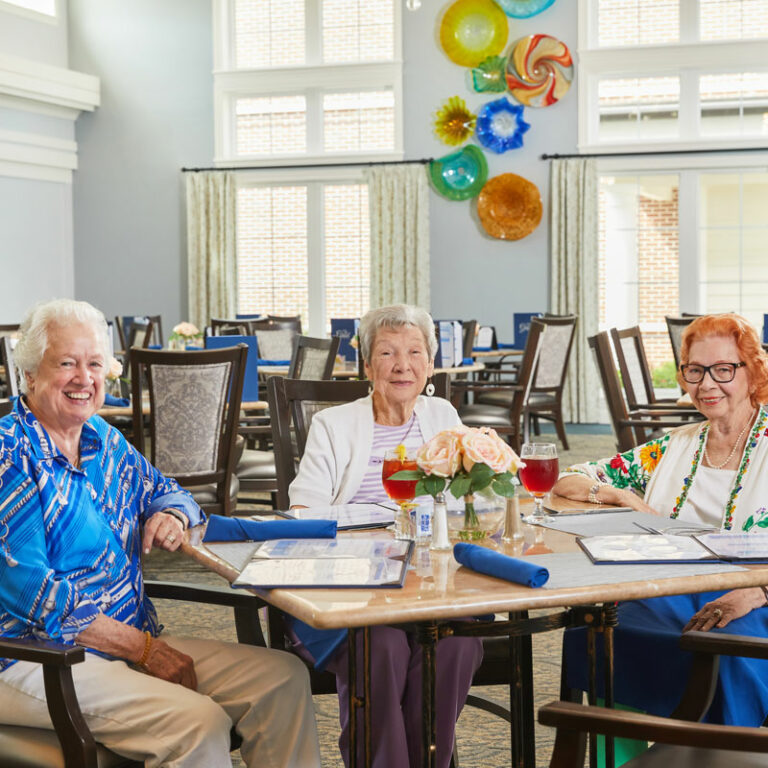 Residents enjoying drinks at a dining table