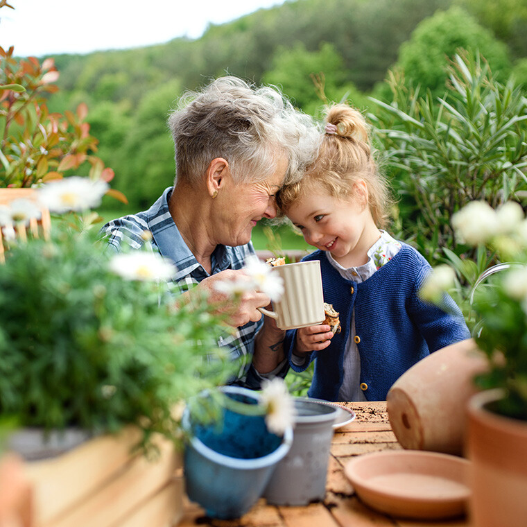 Elderly woman and child enjoying time in a garden