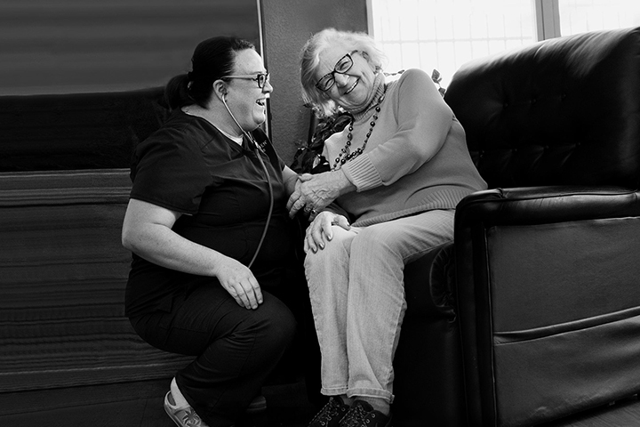 Care staff interacting with a resident in a cozy lounge
