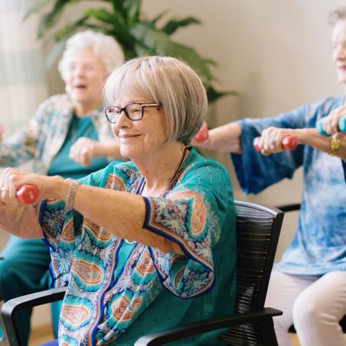 Residents participating in an exercise activity in a bright room