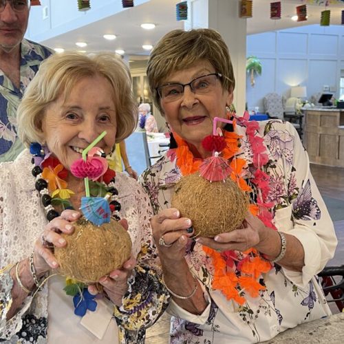 Residents enjoying a festive event with drinks in hand