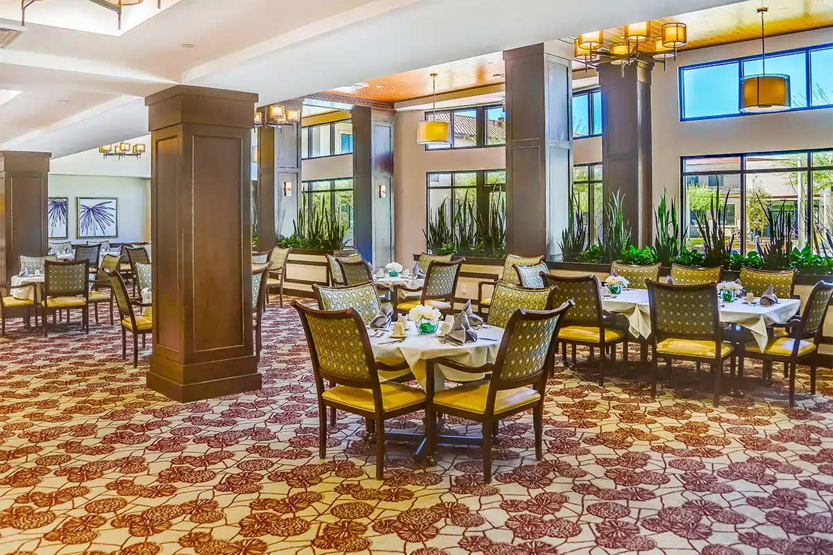 Bright and elegant dining room with tables set for meals