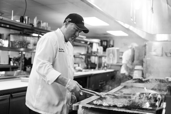 Chef grilling in a kitchen at an assisted living facility