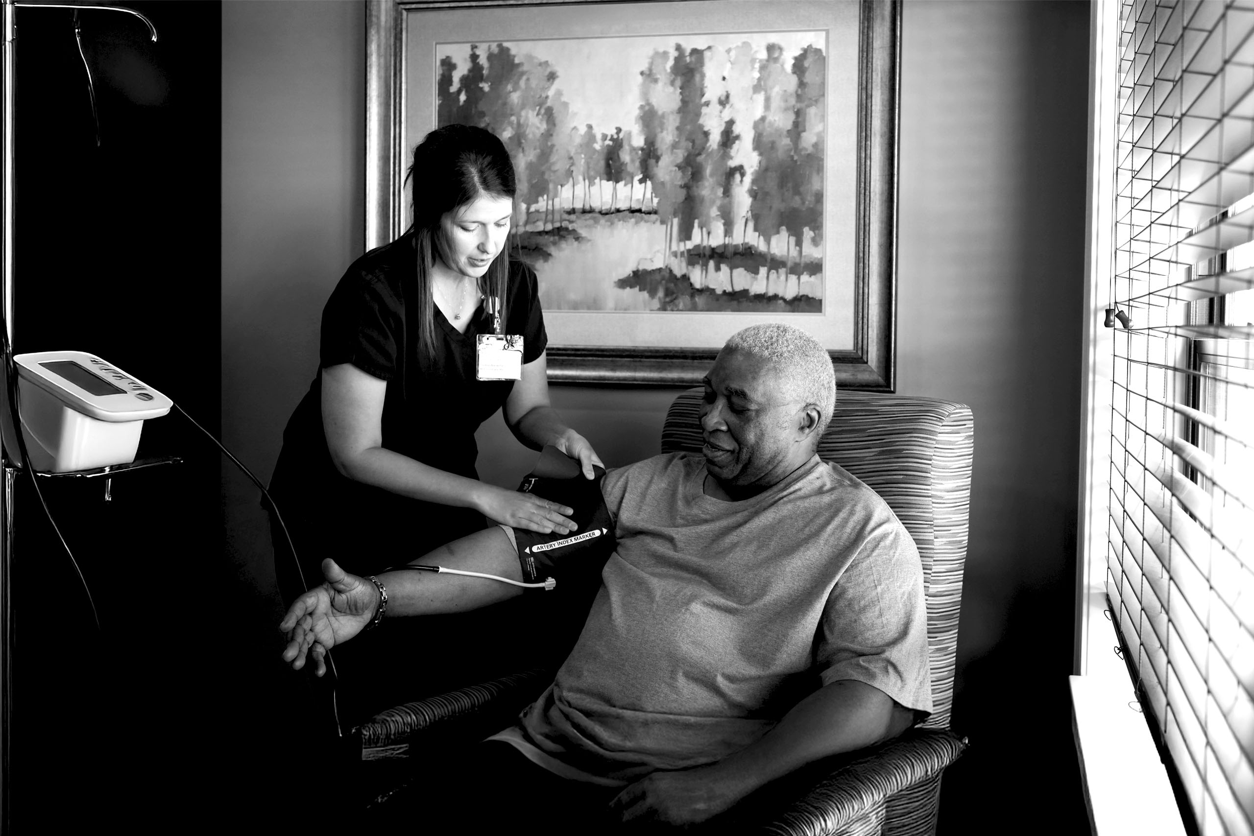 Nurse checking blood pressure of a resident