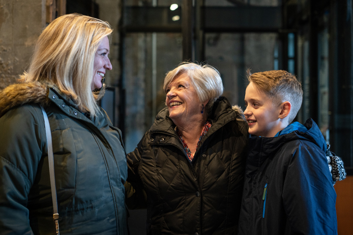 Residents and family members smiling together indoors