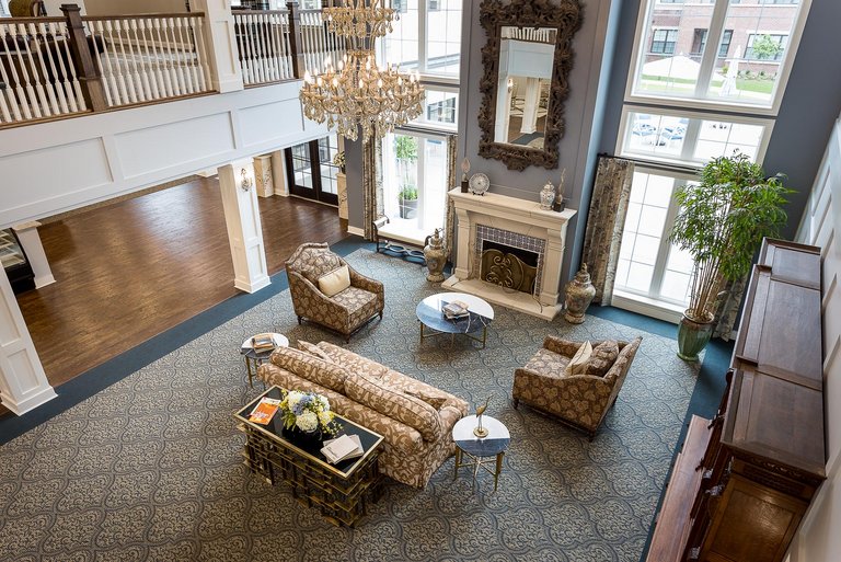 Bright common area with elegant furniture and chandelier