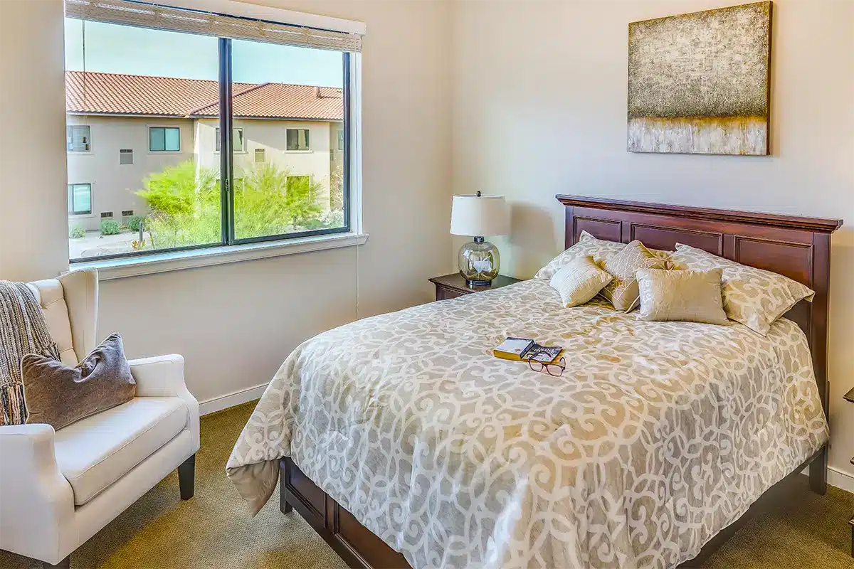 Cozy private resident room with a bed and chair