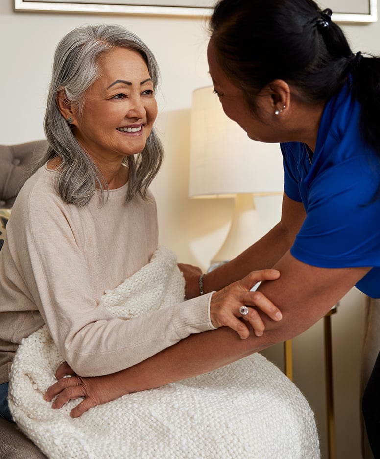 Caregiver interacting with a smiling resident