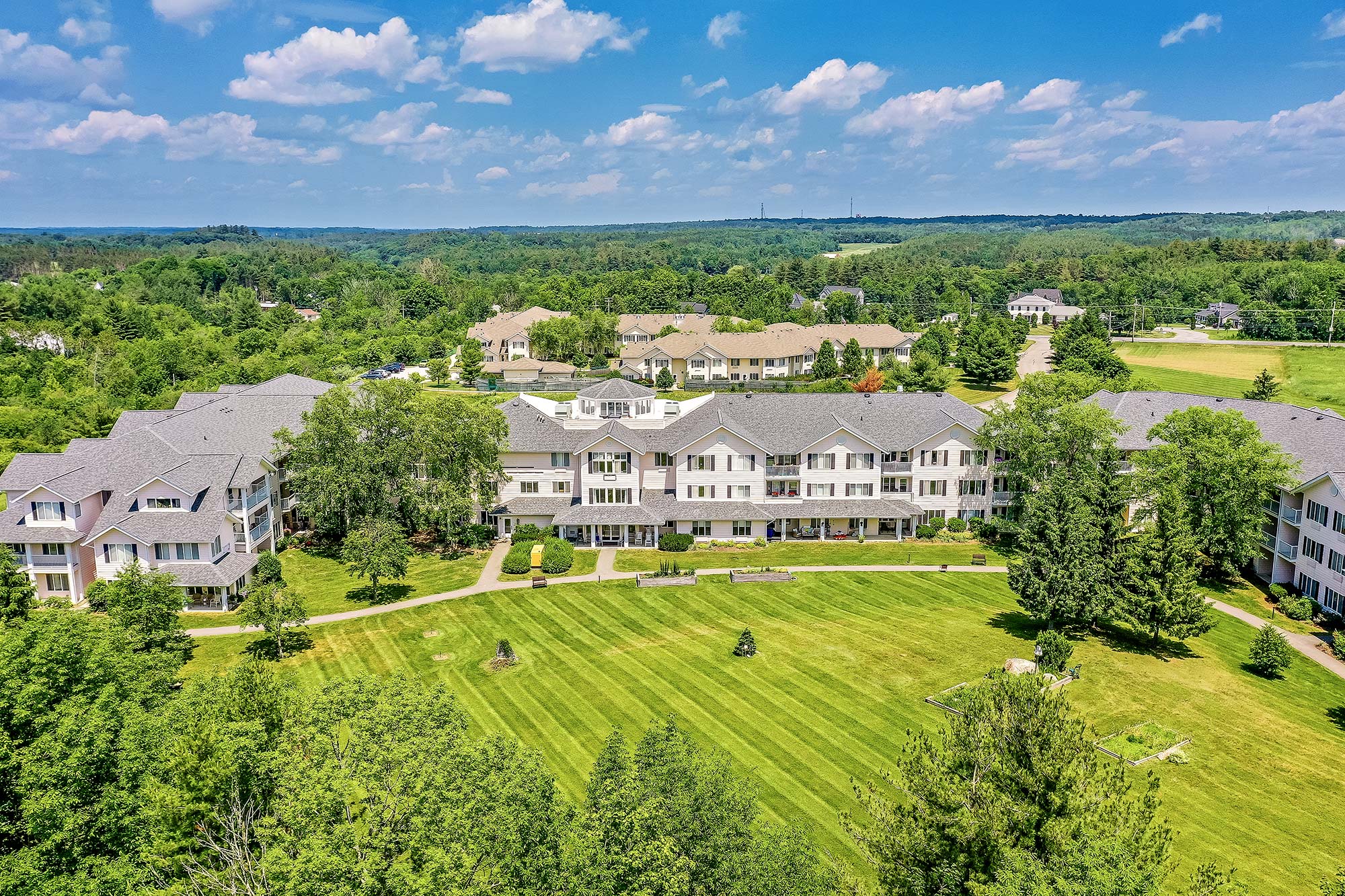 Aerial view of a senior living facility with landscaped grounds