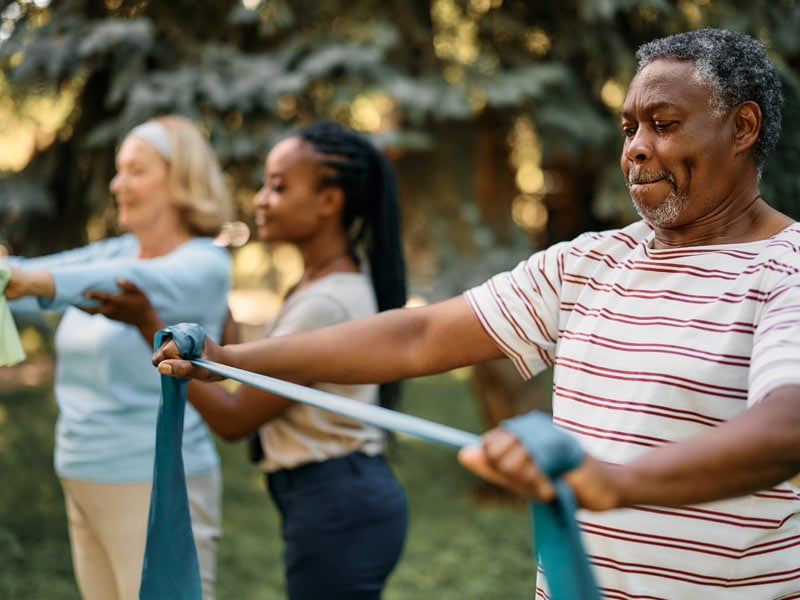 Residents participating in a group exercise activity outdoors