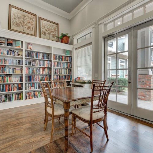 Cozy common area with bookshelves and a table