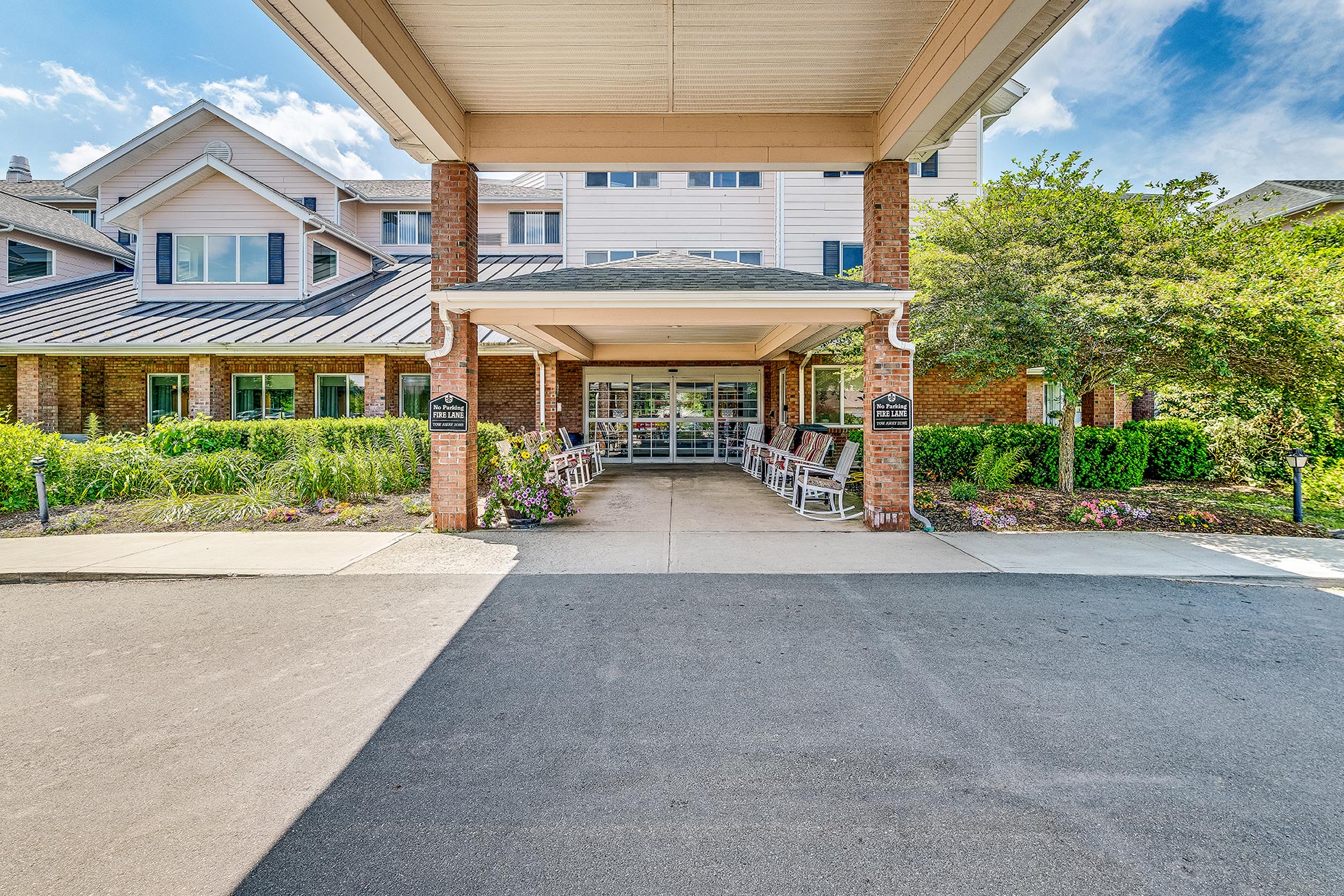 Entrance of Solstice Senior Living at Bangor with rocking chairs