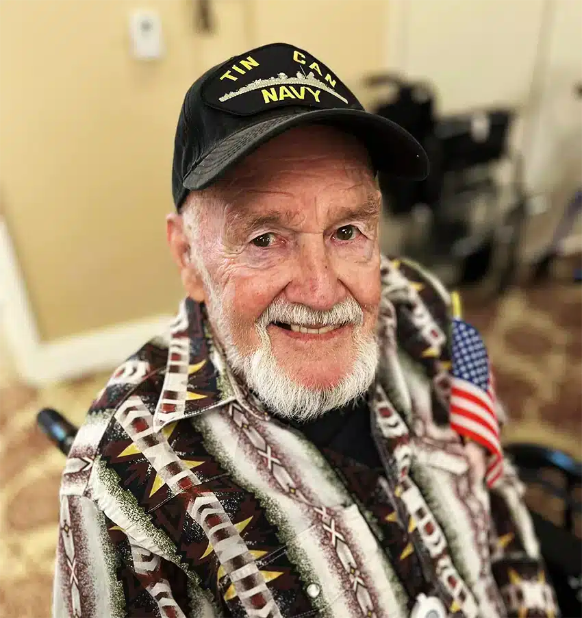 Senior resident smiling in a colorful shirt
