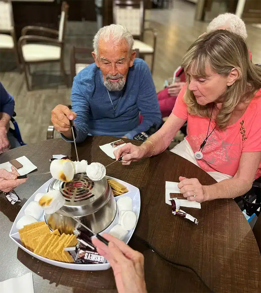 Residents enjoying a s'mores activity in a common area