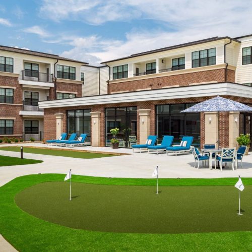 Exterior view of The Grand Senior Living facility and outdoor space