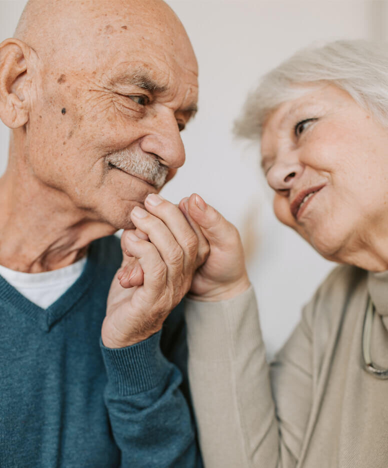 Elderly couple sharing a tender moment indoors