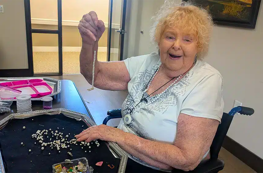 Resident engaged in a craft activity with beads