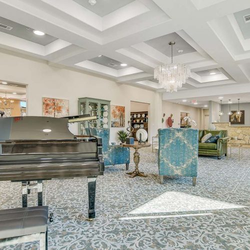 Bright and welcoming common area with a piano