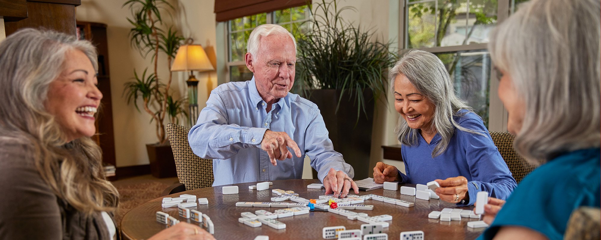 Residents enjoying a game of dominoes in a common area
