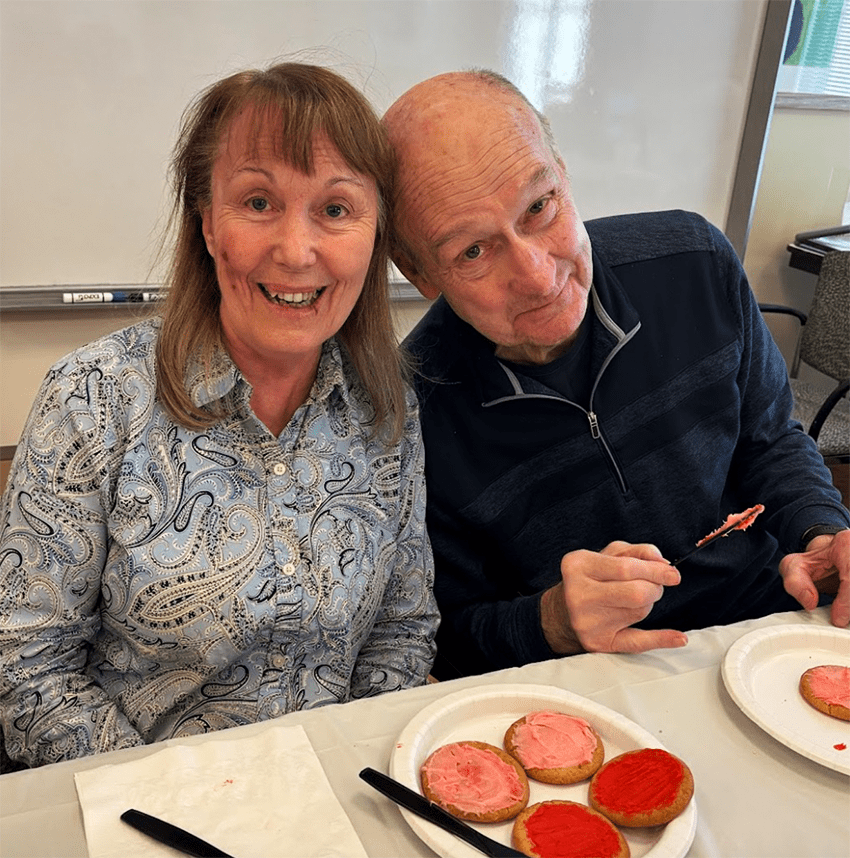 Residents enjoying a cookie decorating activity