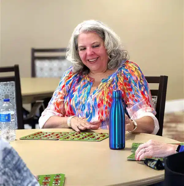 Resident enjoying a bingo game in an activity room