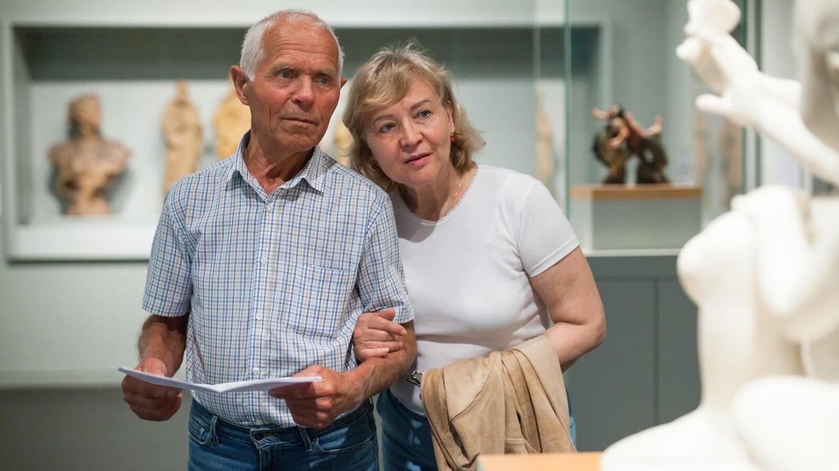 A couple admiring art in an indoor setting