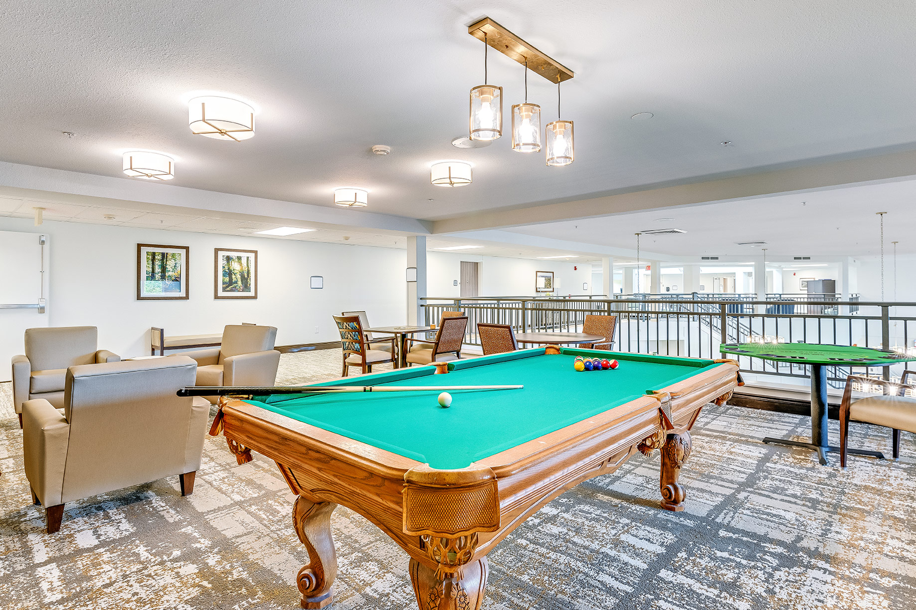 Bright common area with a pool table and seating