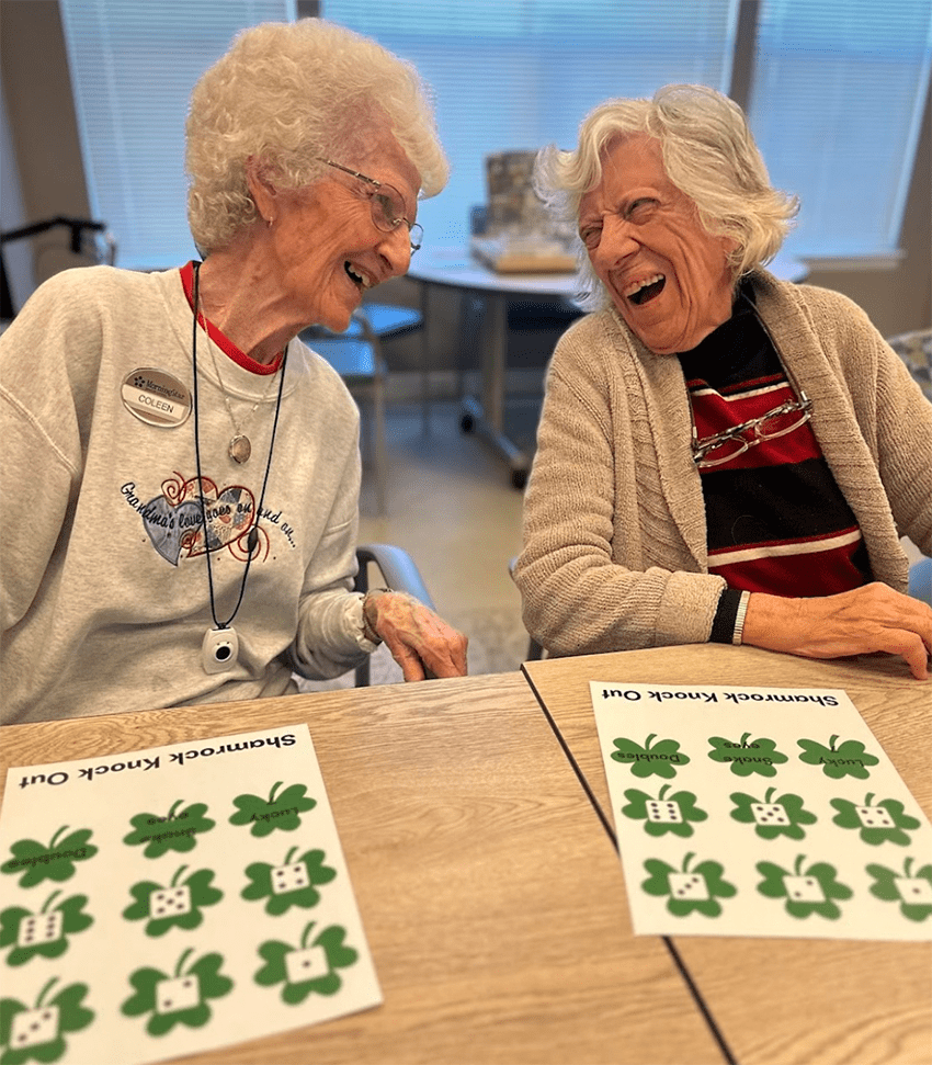 Two residents laughing during an activity.