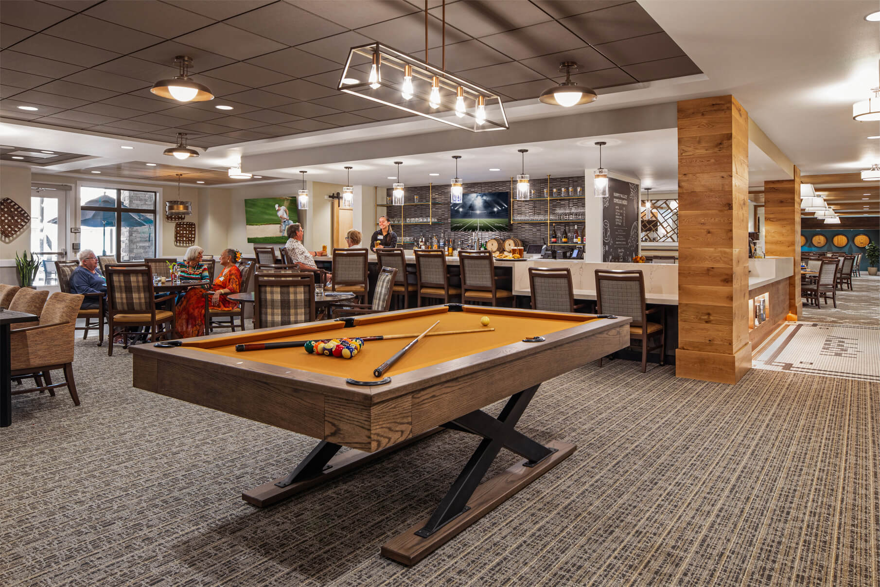 Residents enjoying the activity area with a pool table