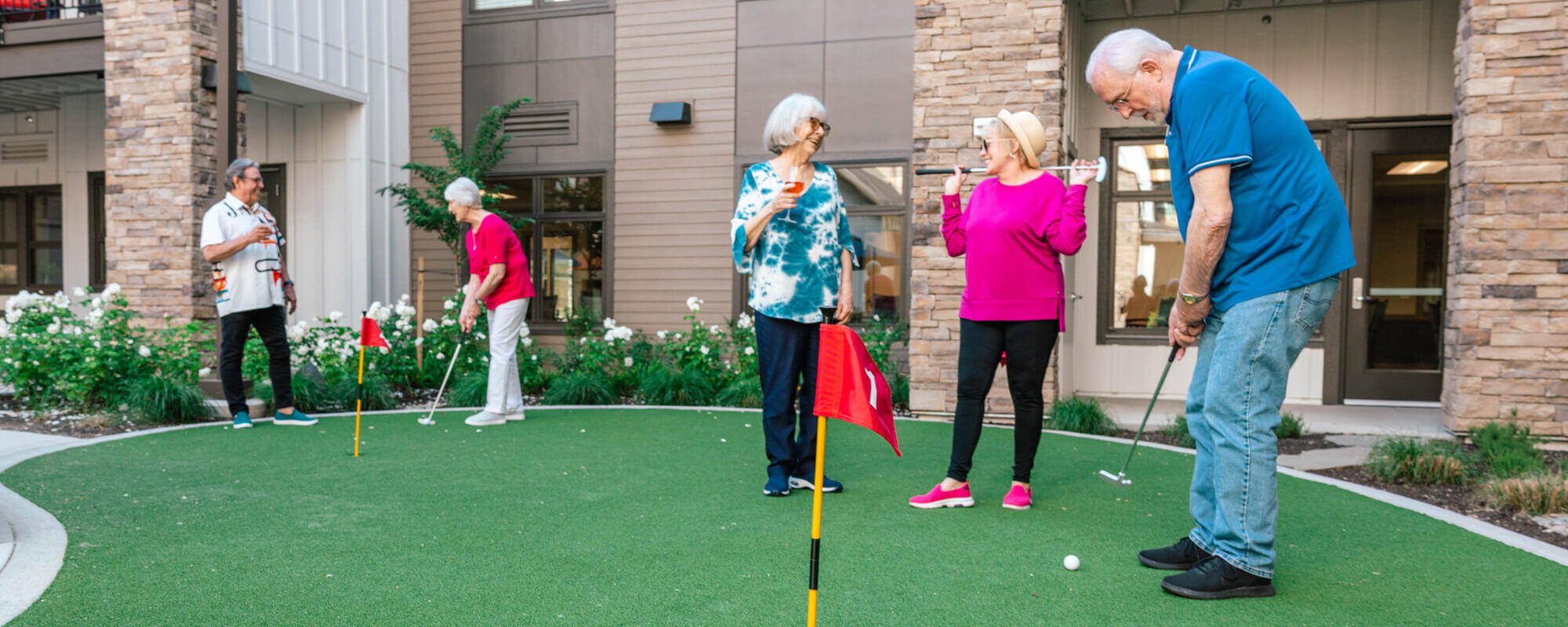 Residents engaging in outdoor putting activity