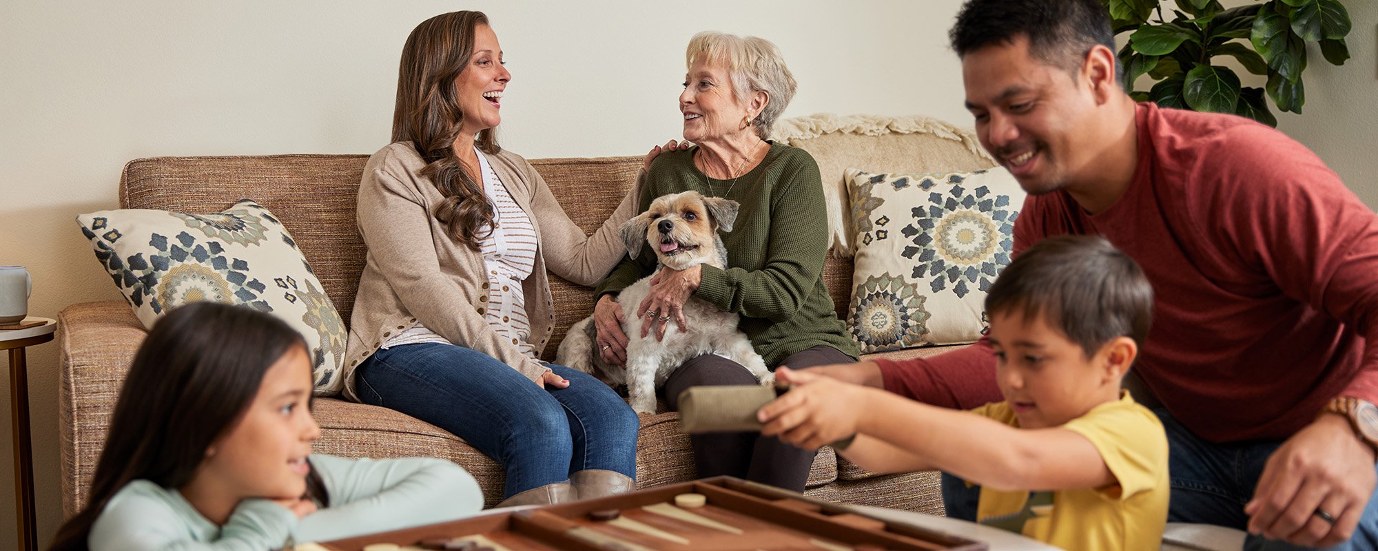 Residents and family enjoying time together with a dog