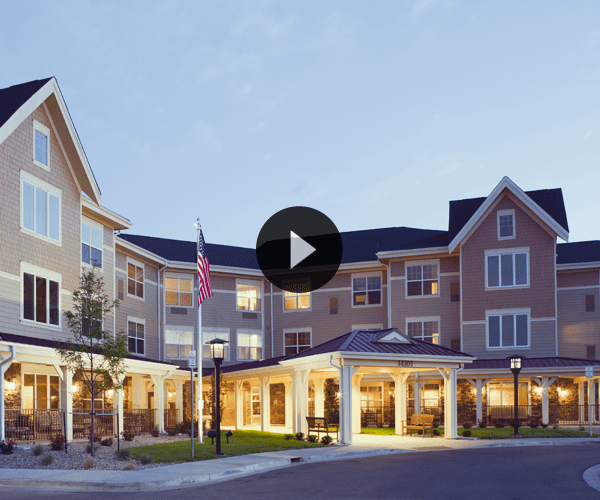 Exterior view of a senior living facility at dusk