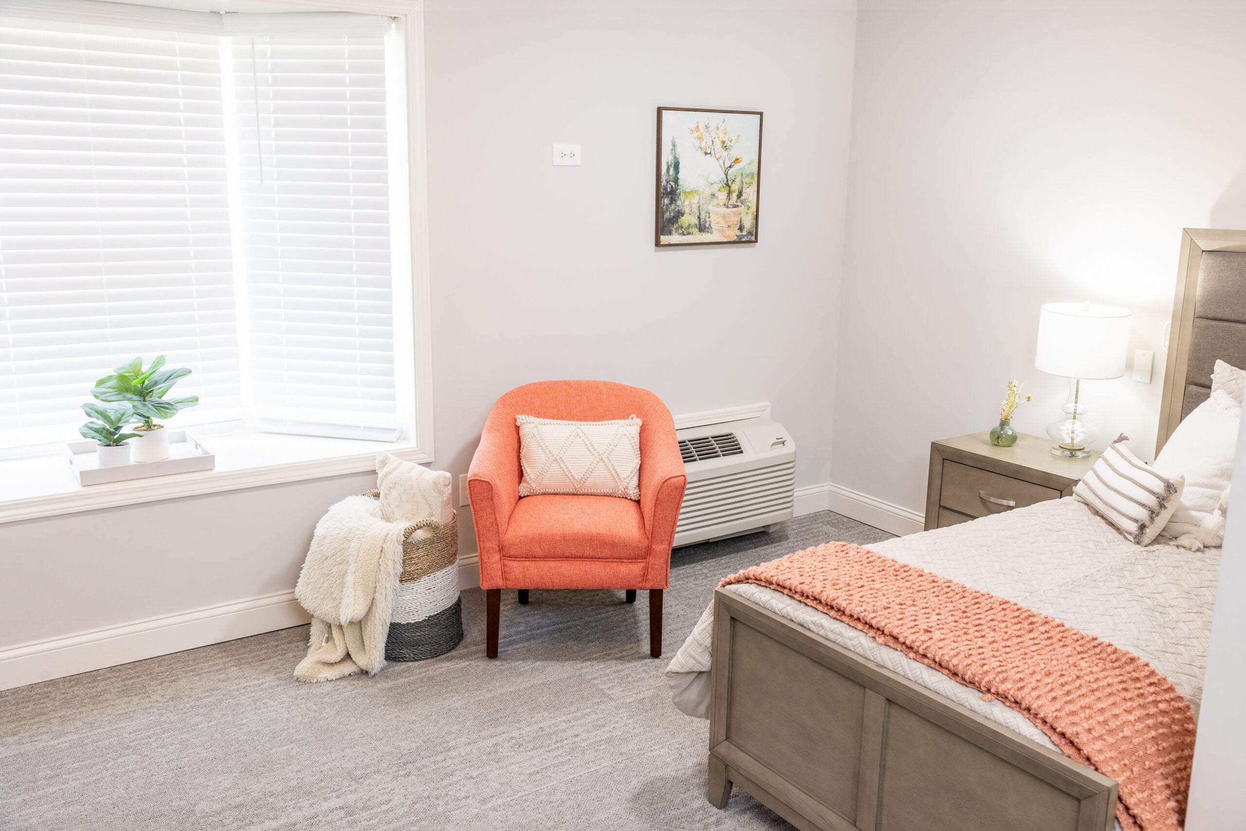 Cozy resident room with an orange armchair and bed