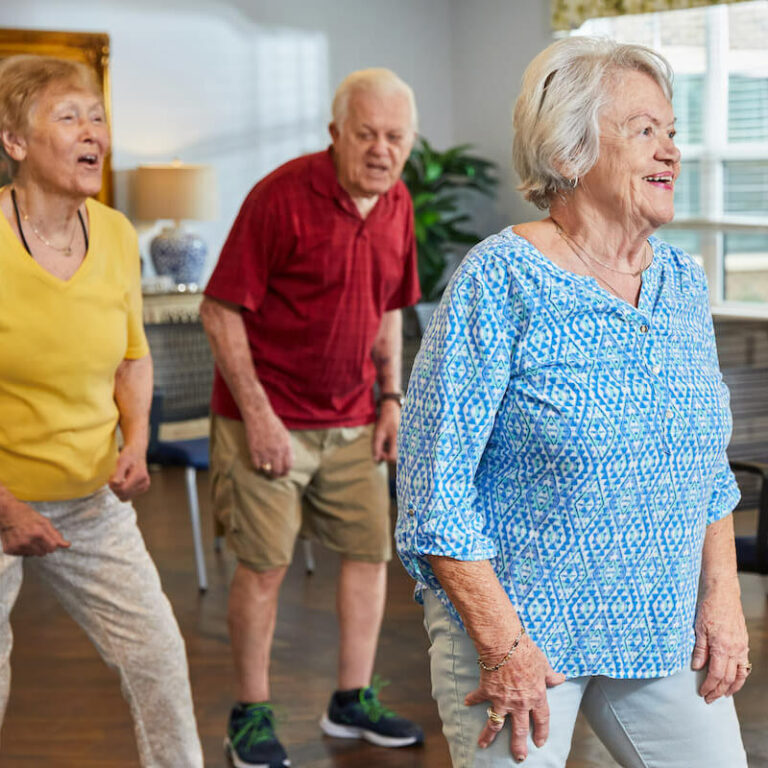 Residents participating in an exercise class in a common area