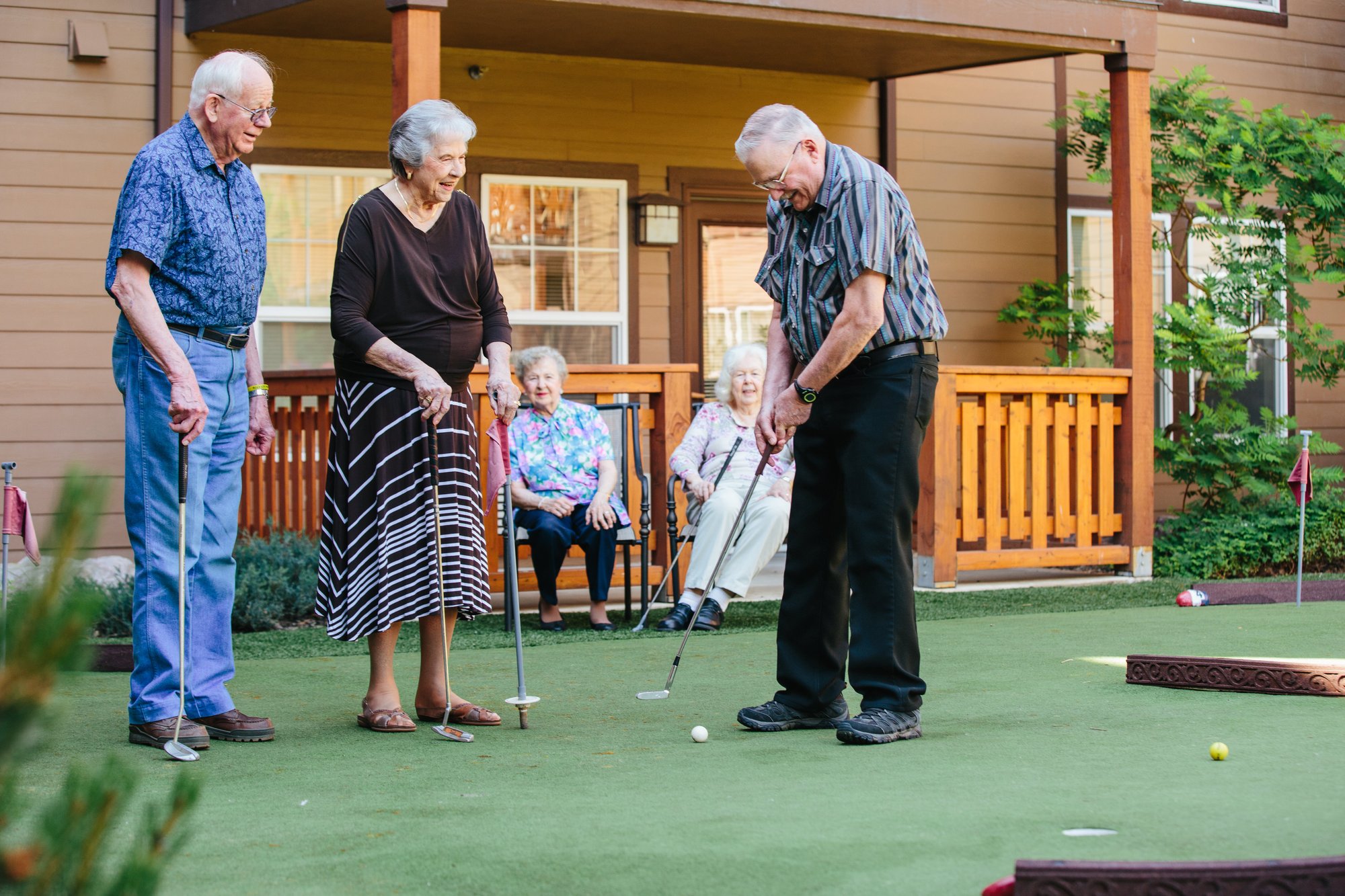 Residents playing mini-golf outdoors