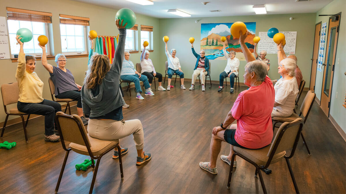 Residents participating in an exercise class with colorful balls